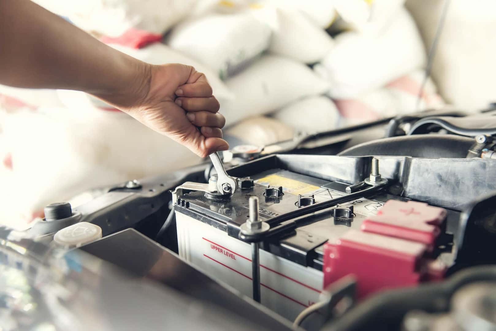 Mechanic replacing battery during battery service near Kingston MA