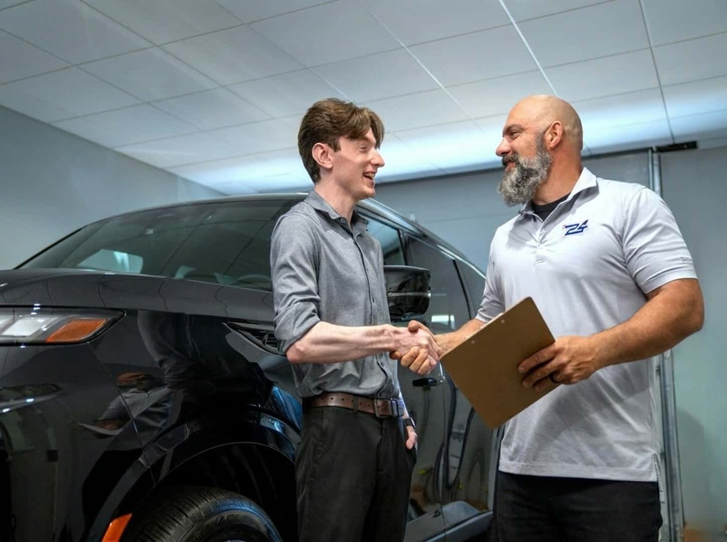 Two Men Shaking Hands in Service Bay