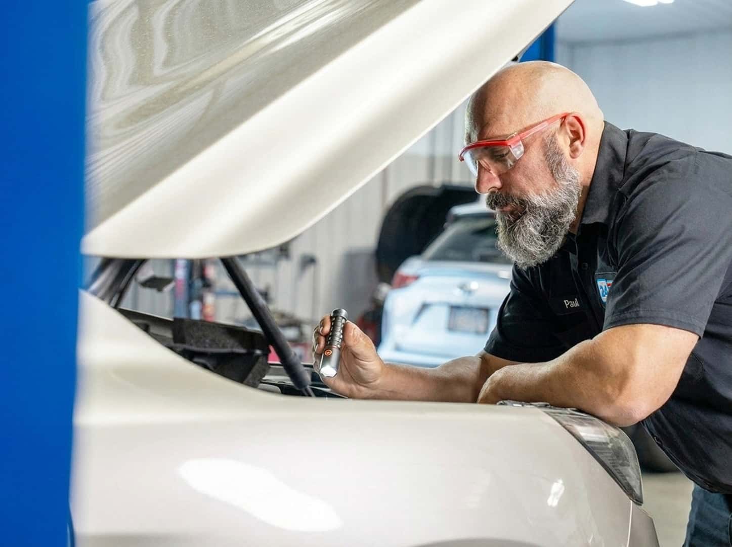 Man Looking Under Hood of Car