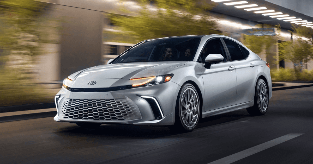 Young people driving a 2026 Toyota Camry at night