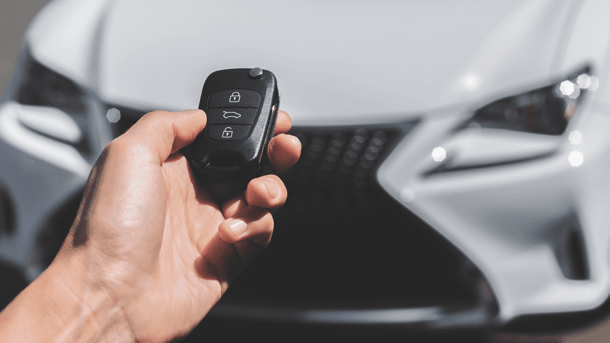 A white car being unlocked by a key fob