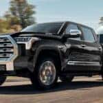 A black Toyota Tundra hauling an airstream RV on the road