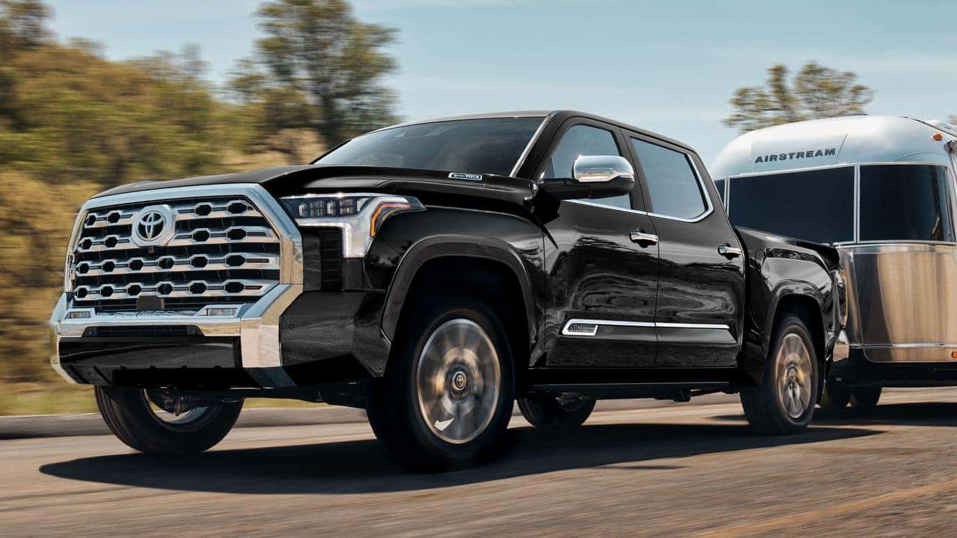 A black Toyota Tundra hauling an airstream RV on the road