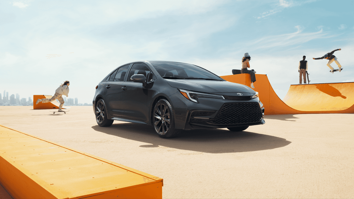 A black Toyota Corolla in the middle of a skate park