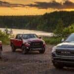 Lineup of 2024 RAM 1500 trucks at sunset