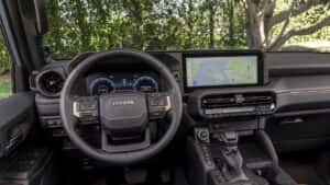 Interior shot of the Toyota Land Cruiser showing the steering wheel and center console