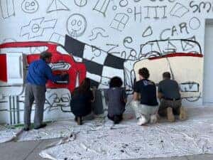 Berger employees painting the mural