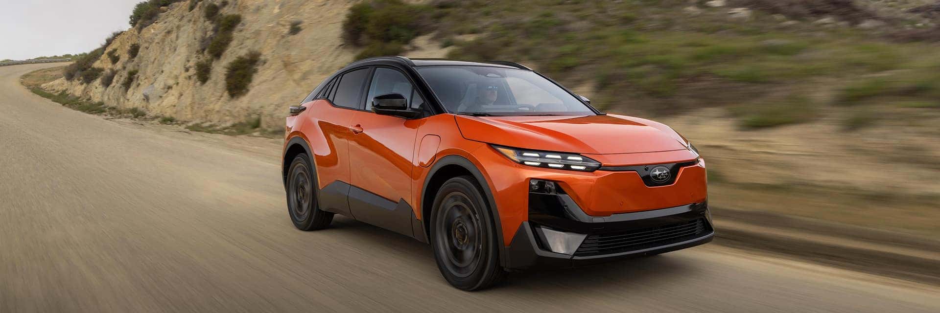 2027 orange uncharted driving down a dirt road