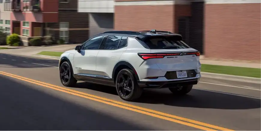 Silver Chevrolet crossover using adaptive cruise control on a divided highway