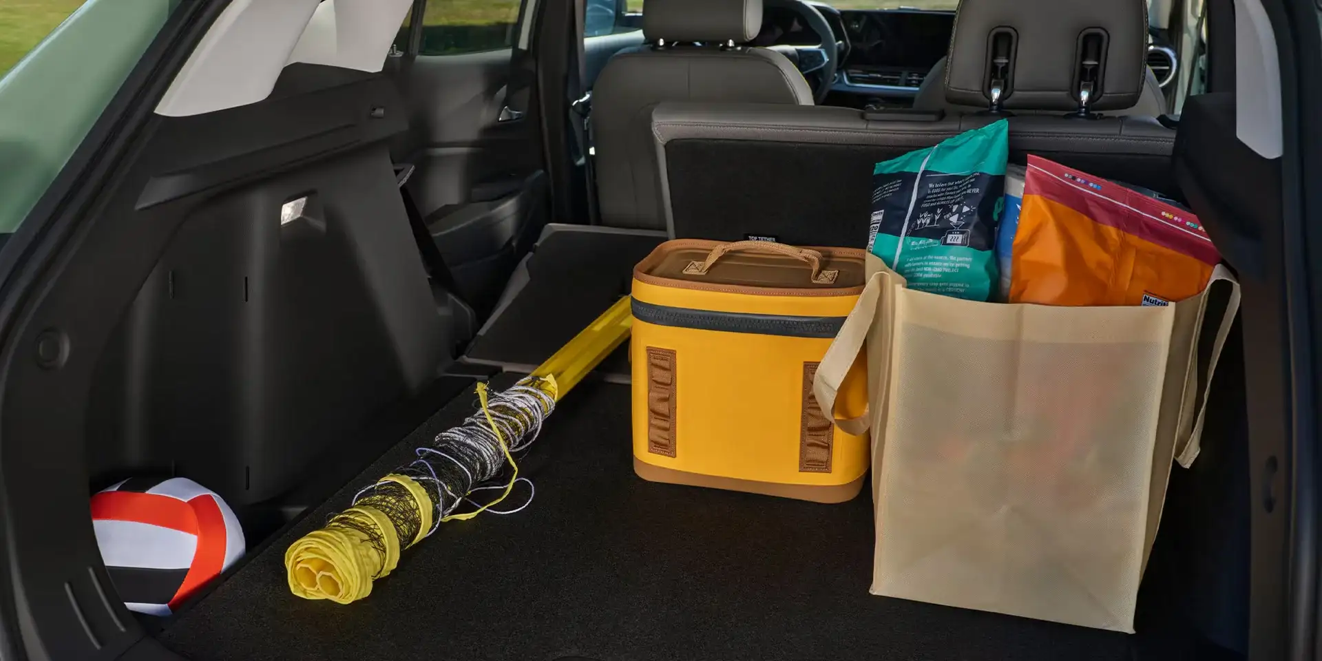 Open cargo area of the 2026 Chevrolet Trax loaded with a cooler and gear