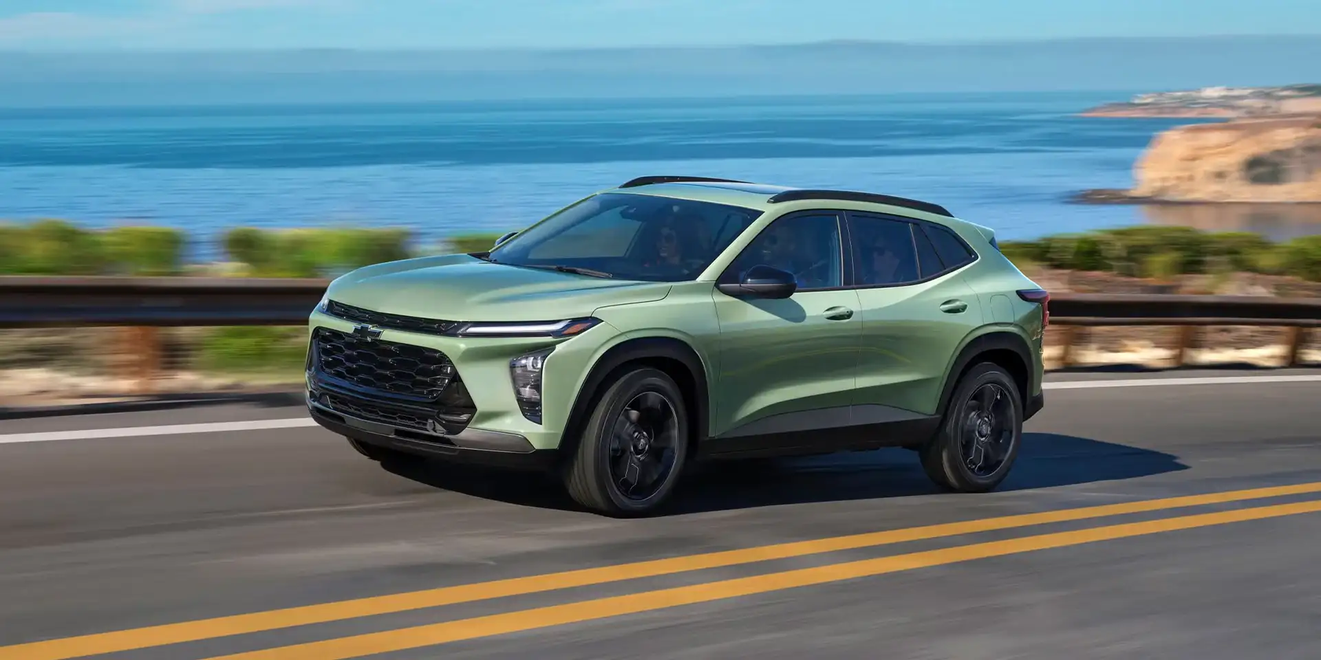 2026 Chevrolet Trax ACTIV in sage green driving on a coastal road