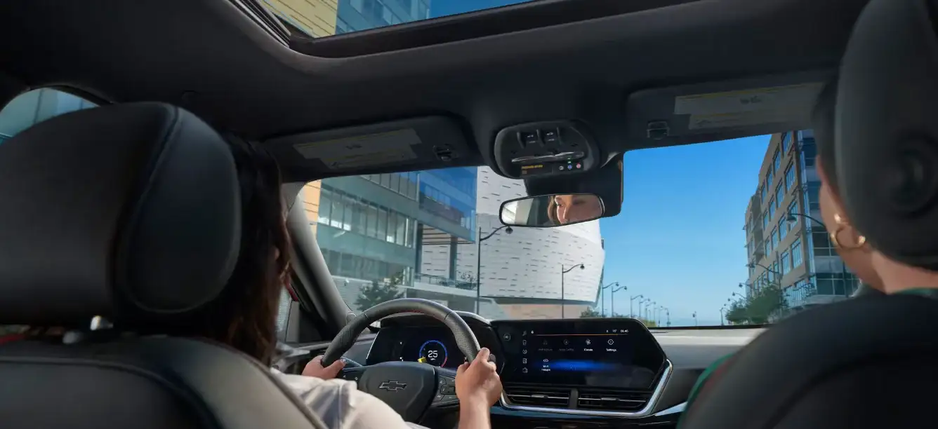 View across the Chevrolet Trax cabin with the driver's hands on the wheel