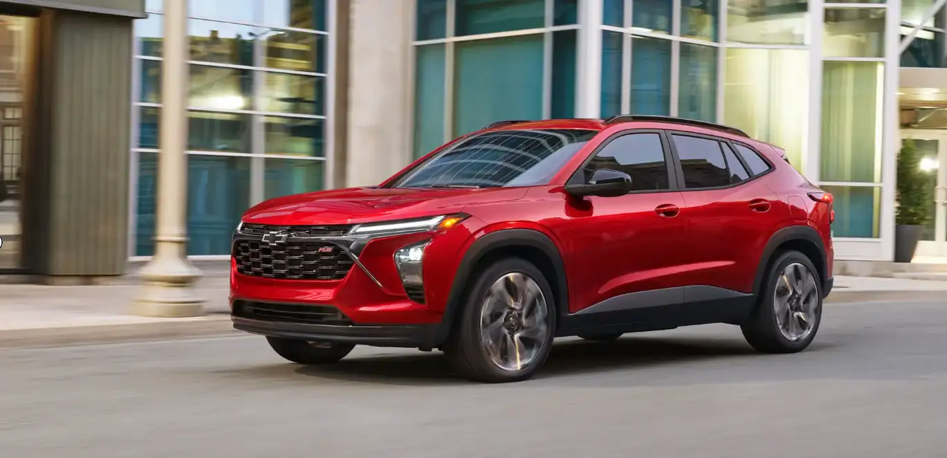 Red Chevrolet Trax front three-quarter view outside a modern building
