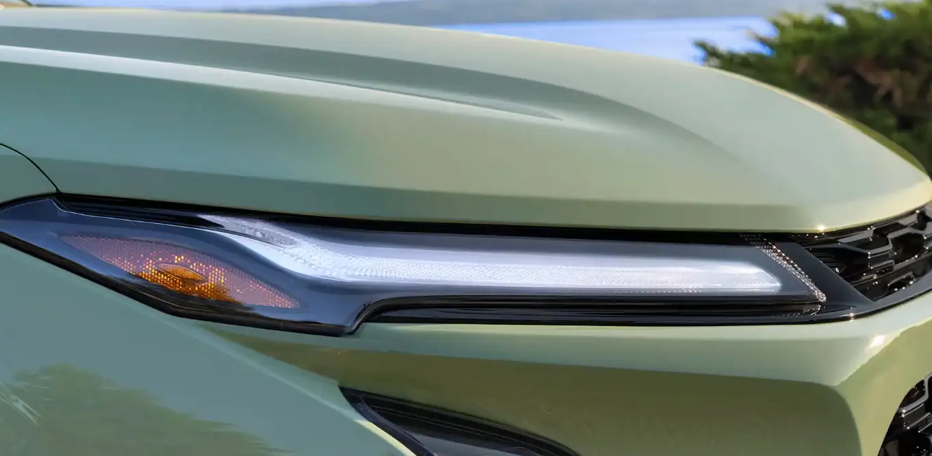 Close-up of the Chevrolet Trax headlamp on a sage green body