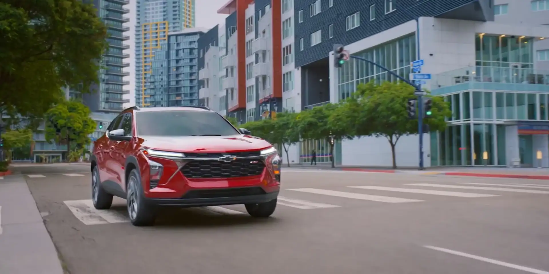 2026 Chevrolet Trax in red driving through a city street