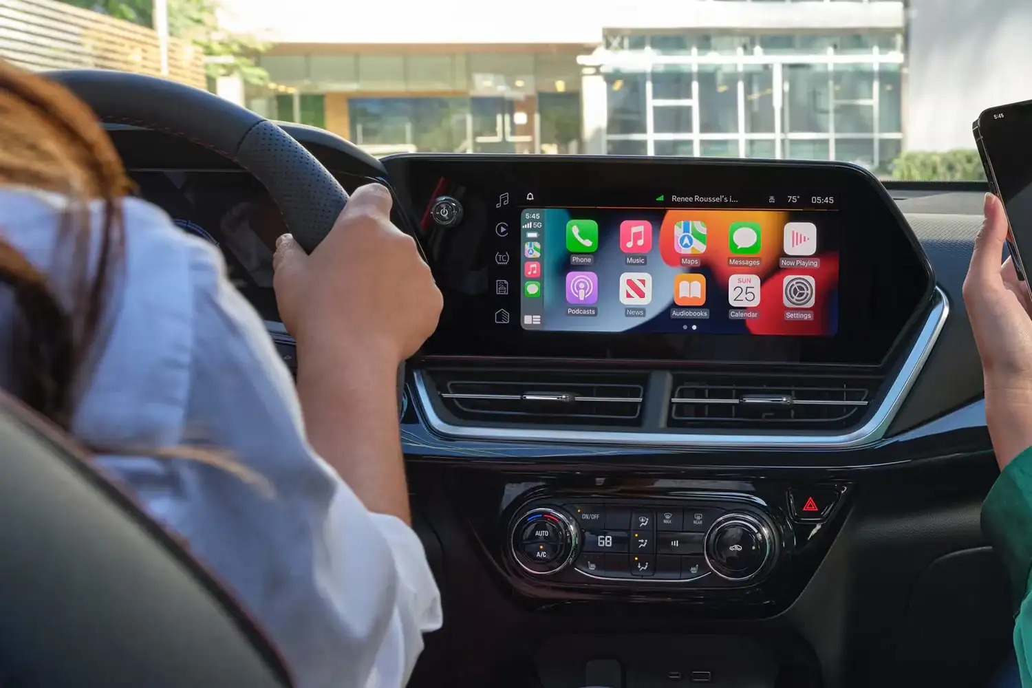 Driver using the 11-inch colour touch-screen in the Chevrolet Trax