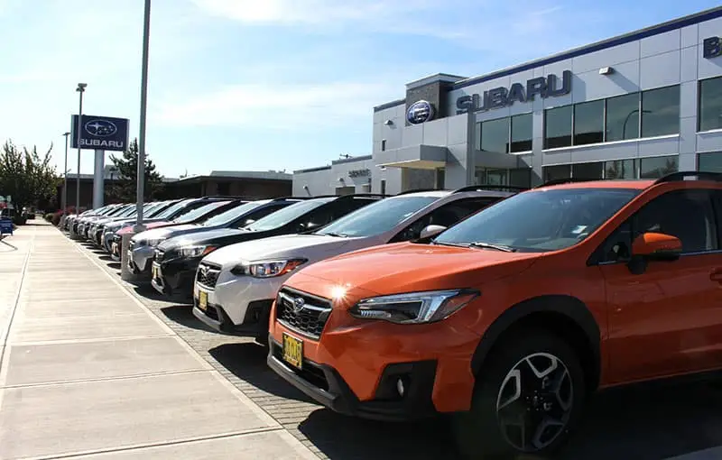 Front entrance of Bud Clary Subaru with Subaru SUVs lined up