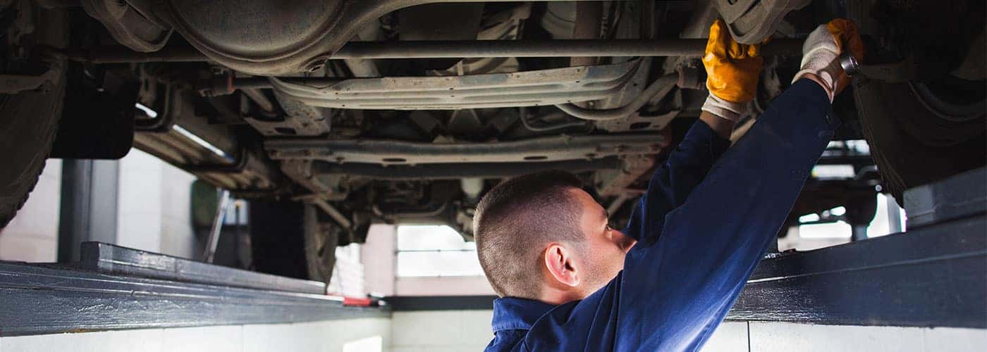 technician working on the suspension of a car
