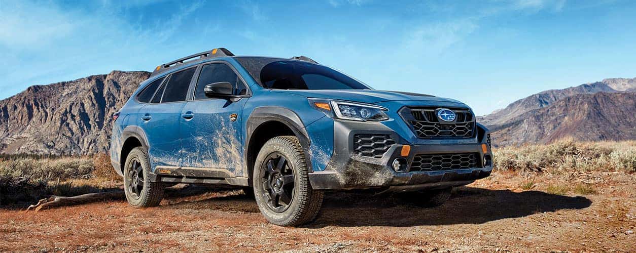 2025 subaru outback in blue parked in the desert