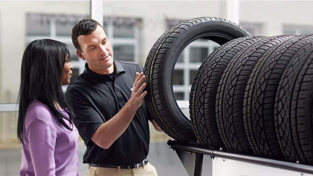 Subaru staff helping someone choose a tire