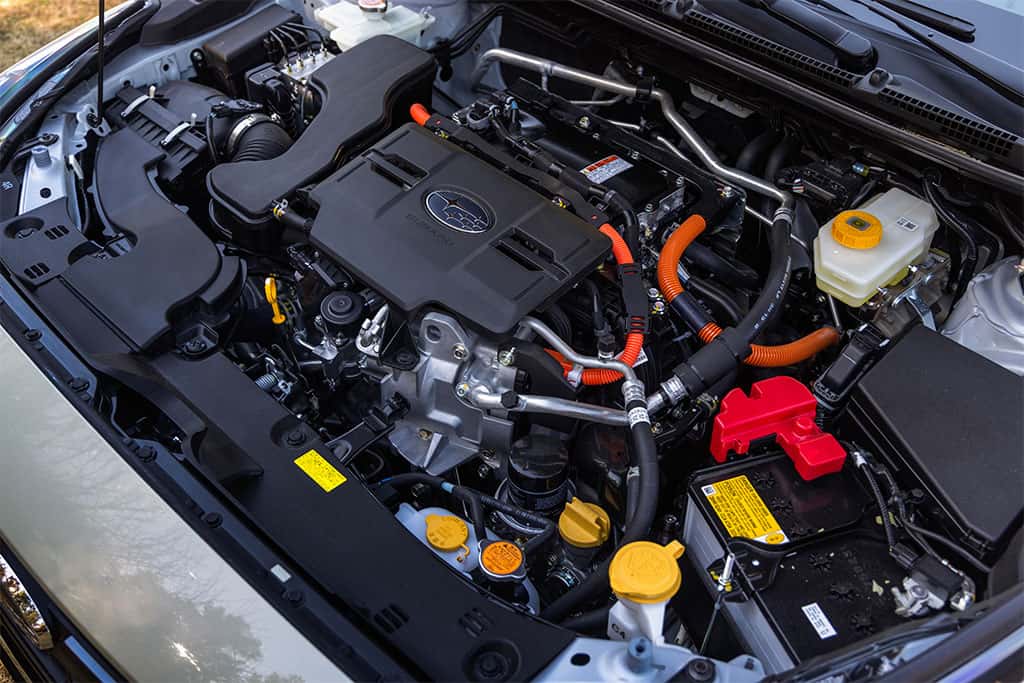2026 Subaru Crosstrek Hybrid with hood open showing off hybrid system combining 2.5-liter SUBARU BOXER® engine with electric motors and high-capacity lithium-ion battery