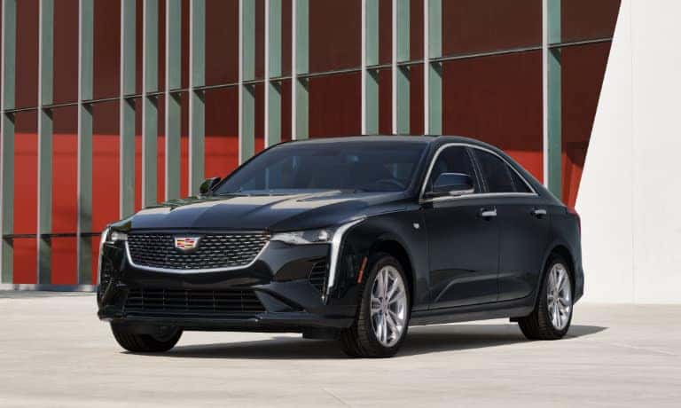 2022 Cadillac CT4 parked in front of a contemporary building
