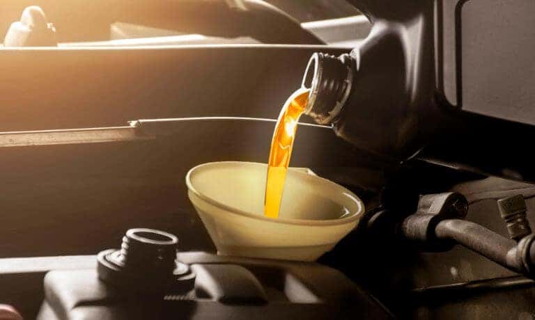 Oil being poured into a funnel