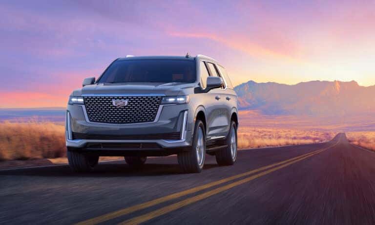 2024 Cadillac Escalade driving head on at sunset