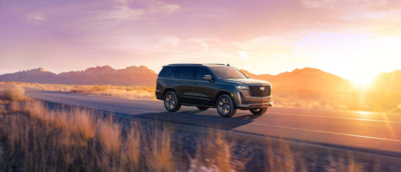 2024 Cadillac Escalade driving under lavender sky