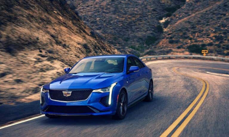 2024 Cadillac CT4 driving on curved mountain road