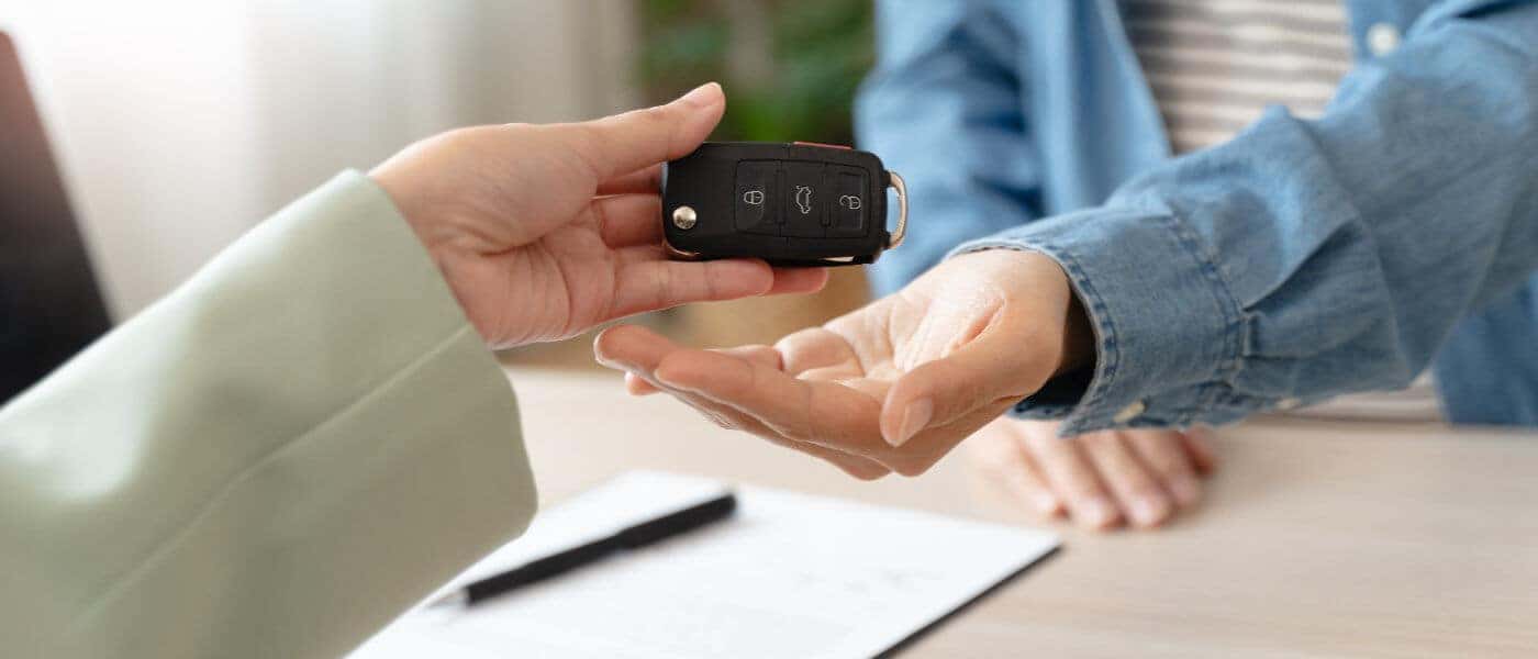 Keys exchanging hands in dealership