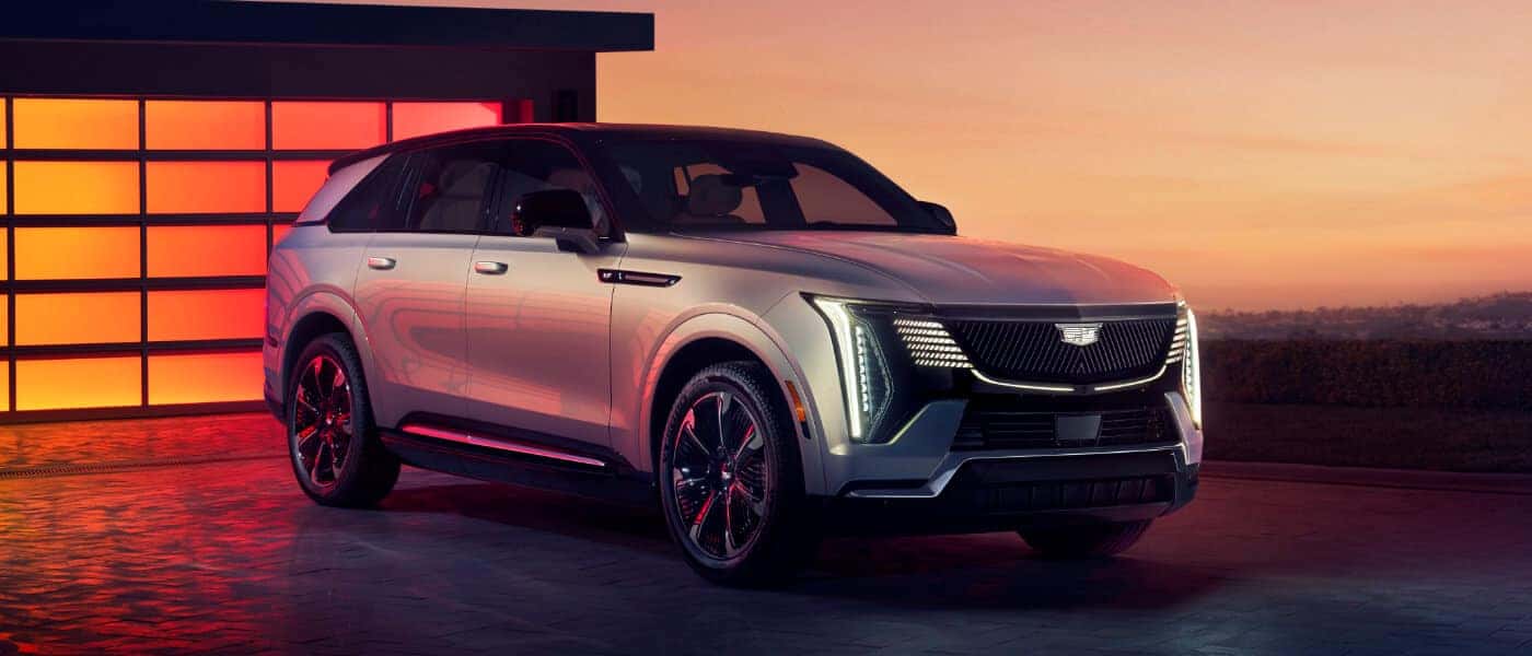 2026 Cadillac ESCALADE IQ parked on a driveway at sunset