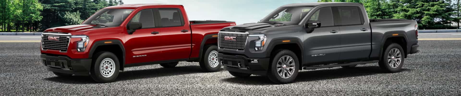 Red and gray GMC Sierra pickup trucks shown side by side.