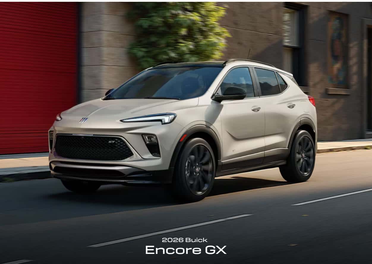 Sleek 2026 Buick Encore GX in motion on a city street, showcasing modern design and sporty aesthetics. Urban setting with vibrant colors.