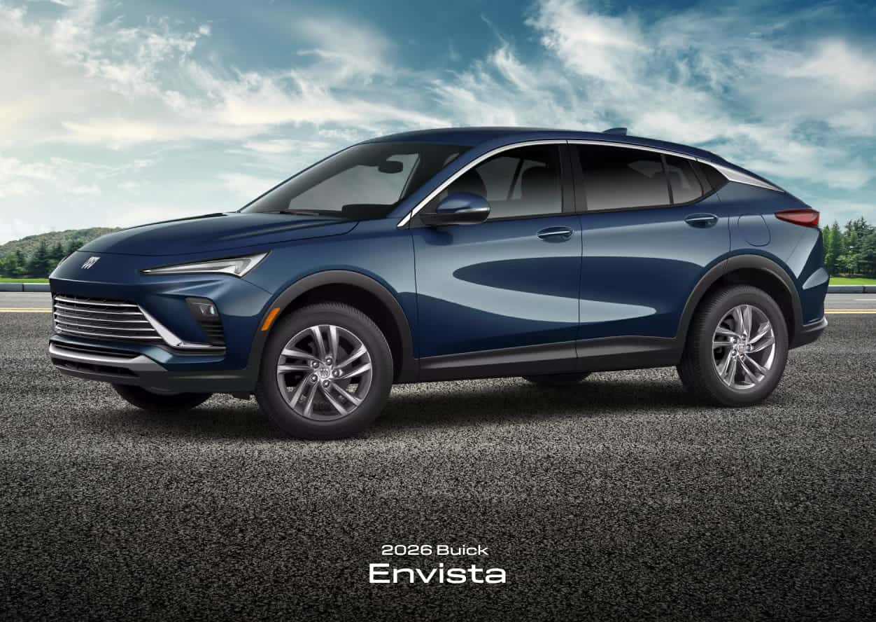 2026 Buick Envista in blue, parked on a road under a partly cloudy sky.