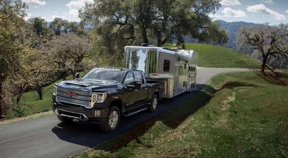 Black 2021 GMC Sierra 2500 HD Denali towing a trialer