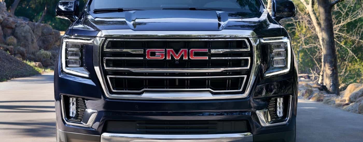 Chrome grille on a dark blue 2023 GMC Yukon SLT