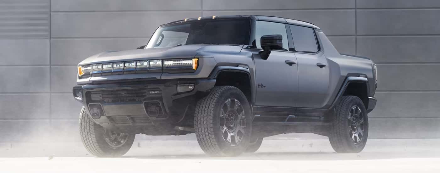 Grey 2026 GMC Hummer EV Pickup Carbon Fiber parked near a wall