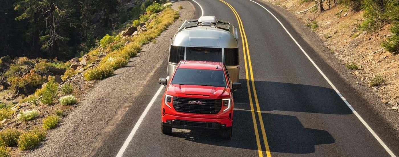 Red 2026 GMC Sierra 1500 Pro towing an airstream trailer