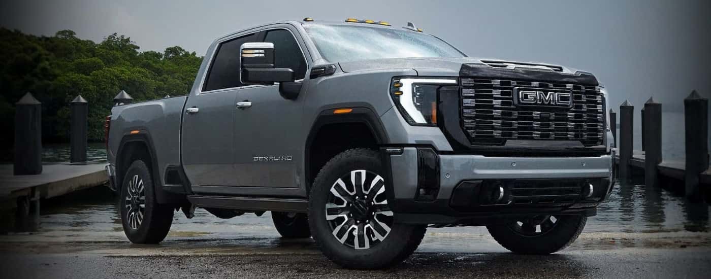 Grey 2026 GMC Sierra 3500 HD Denali Ultimate parked near a dock