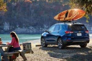 2022 Blue Chevrolet Equinox hauling a kayak at a campsite
