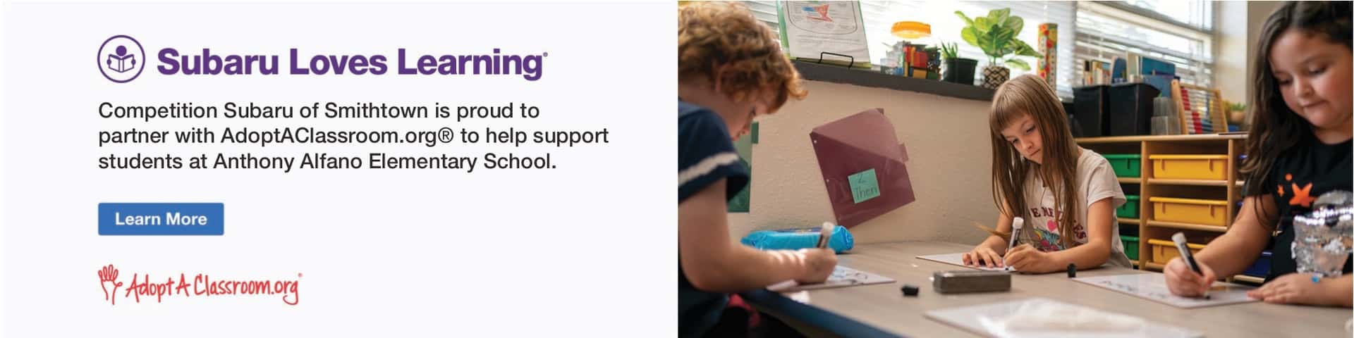 Children writing on mini whiteboards in a classroom