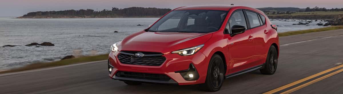 Red Subaru Impreza Driving Along Coast