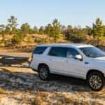 2026 GMC Yukon XL with a trailer on a Sandhills pine-lined road in Richmond County NC