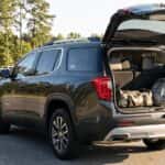 2027 GMC Acadia with liftgate open and sports gear loaded, in a Rockingham NC school pickup line