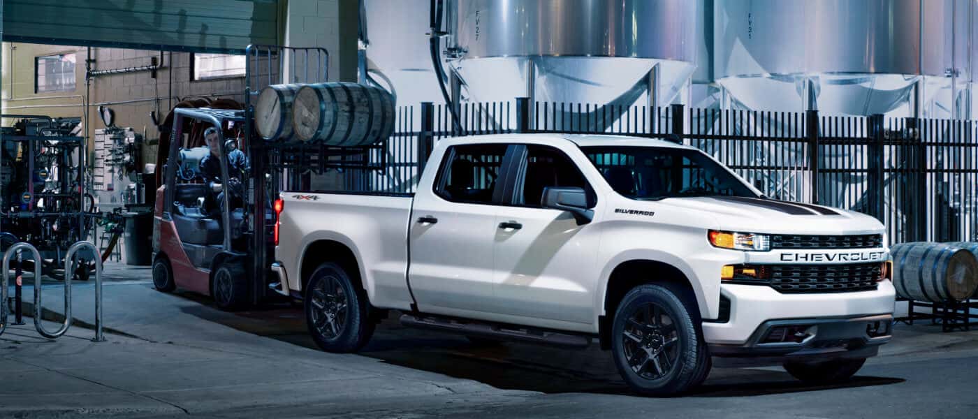 2026 Chevy Silverado 1500 with cargo being loaded in bed