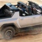 Hummer EV Supertruck driving through sand