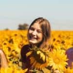 Three Young Women Smiling in Sunflowers