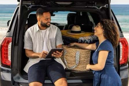 Couple in Back of GMC with Liftgate Up