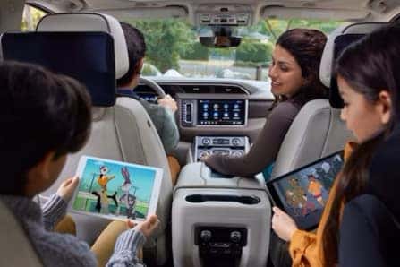 Family in Car Watching Cartoons on Tablets
